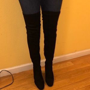 tall over-the-knee black boots.